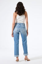 Back view of model wearing high-rise straight-leg jeans, showing the rear fit, pocket placement, and straight-leg silhouette.