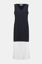Sleeveless midi dress with a navy upper bodice and contrasting white lower skirt, featuring a subtle V-neckline and a straight silhouette.