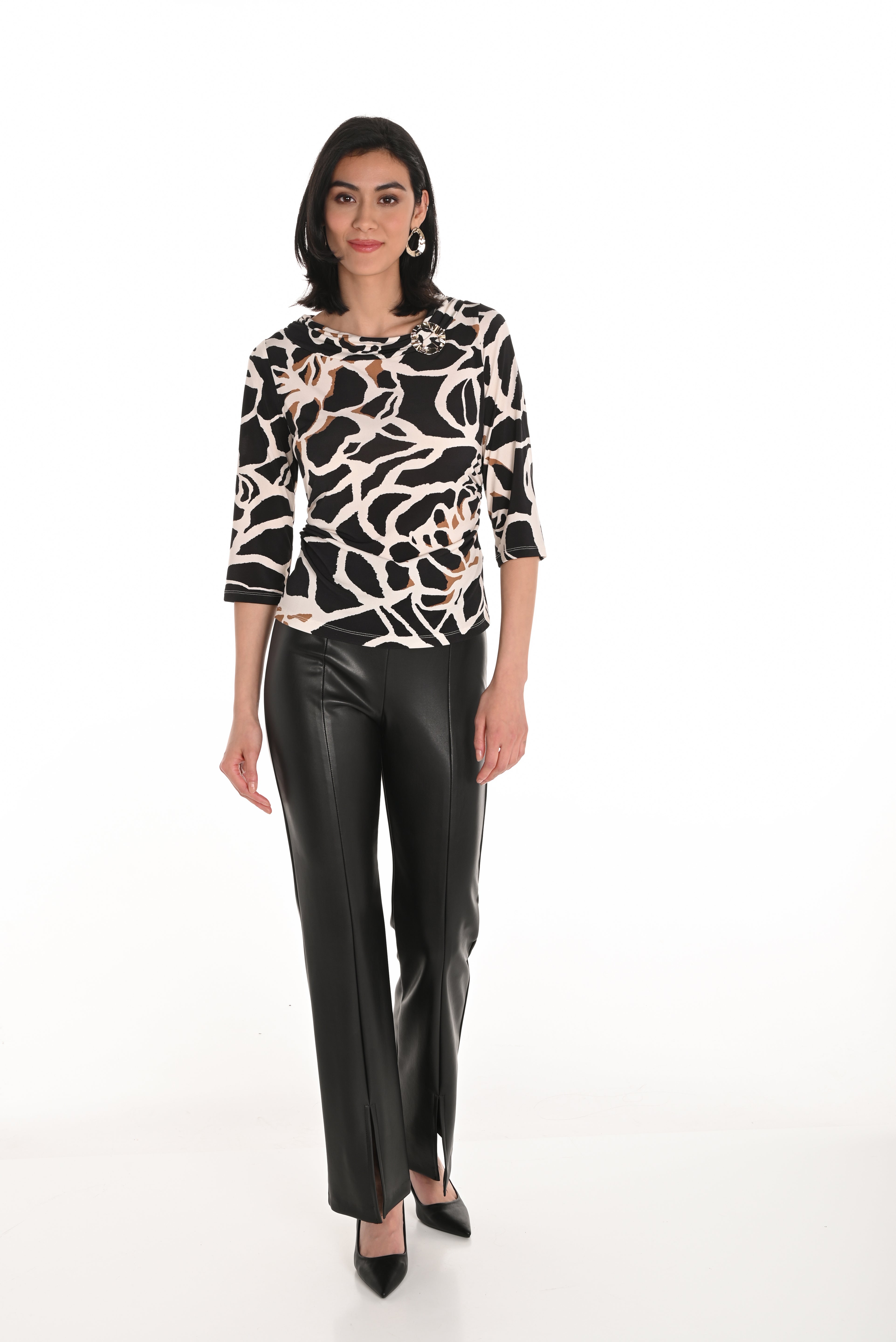 Model wearing high waisted vegan leather trousers 253134 paired with a stylish printed top and heels.