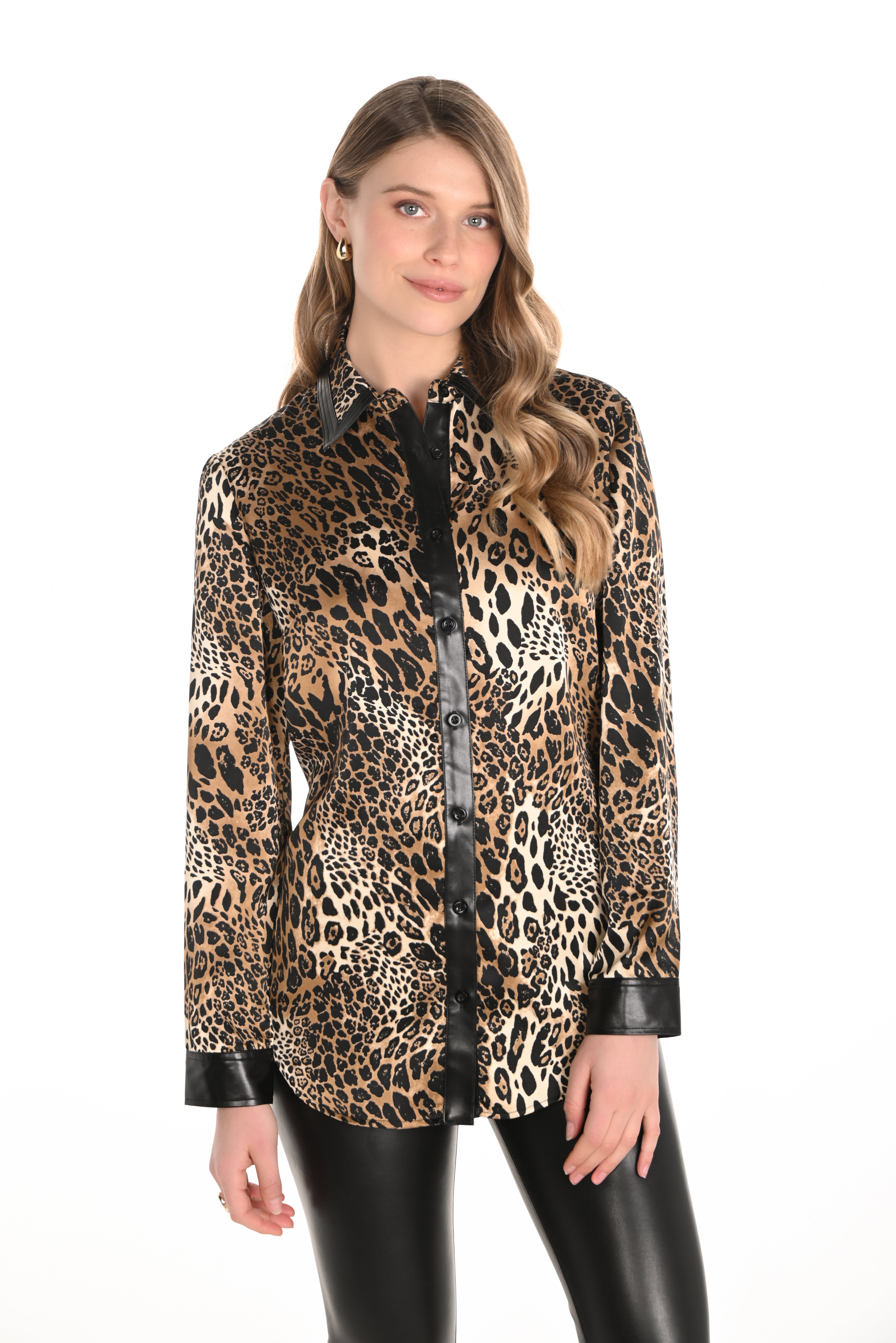 Woman wearing a leopard print jacket with black leather accents on a white background