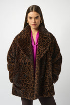 Woman wearing a leopard print coat on a white background