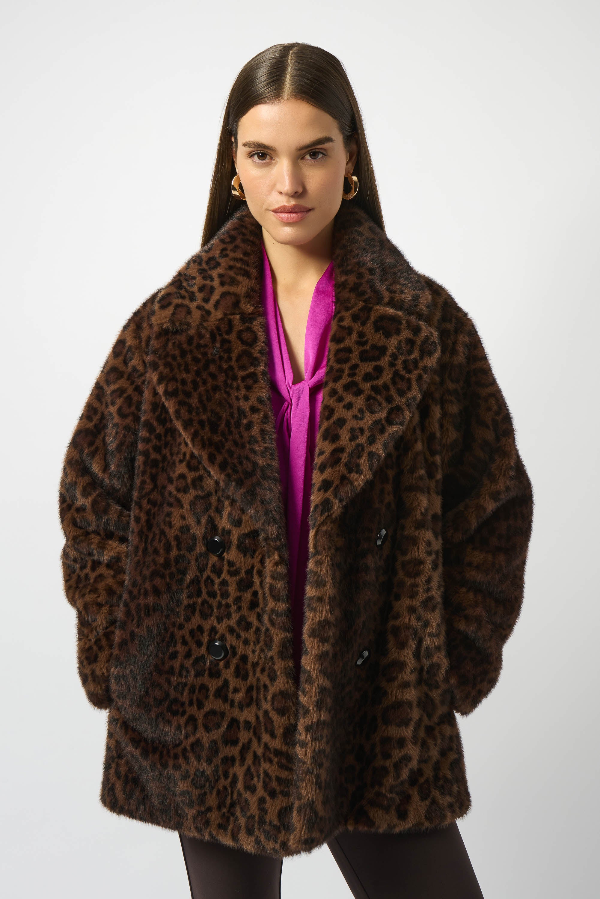 Woman wearing a leopard print coat on a white background