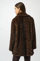Person wearing a leopard print coat on a white background