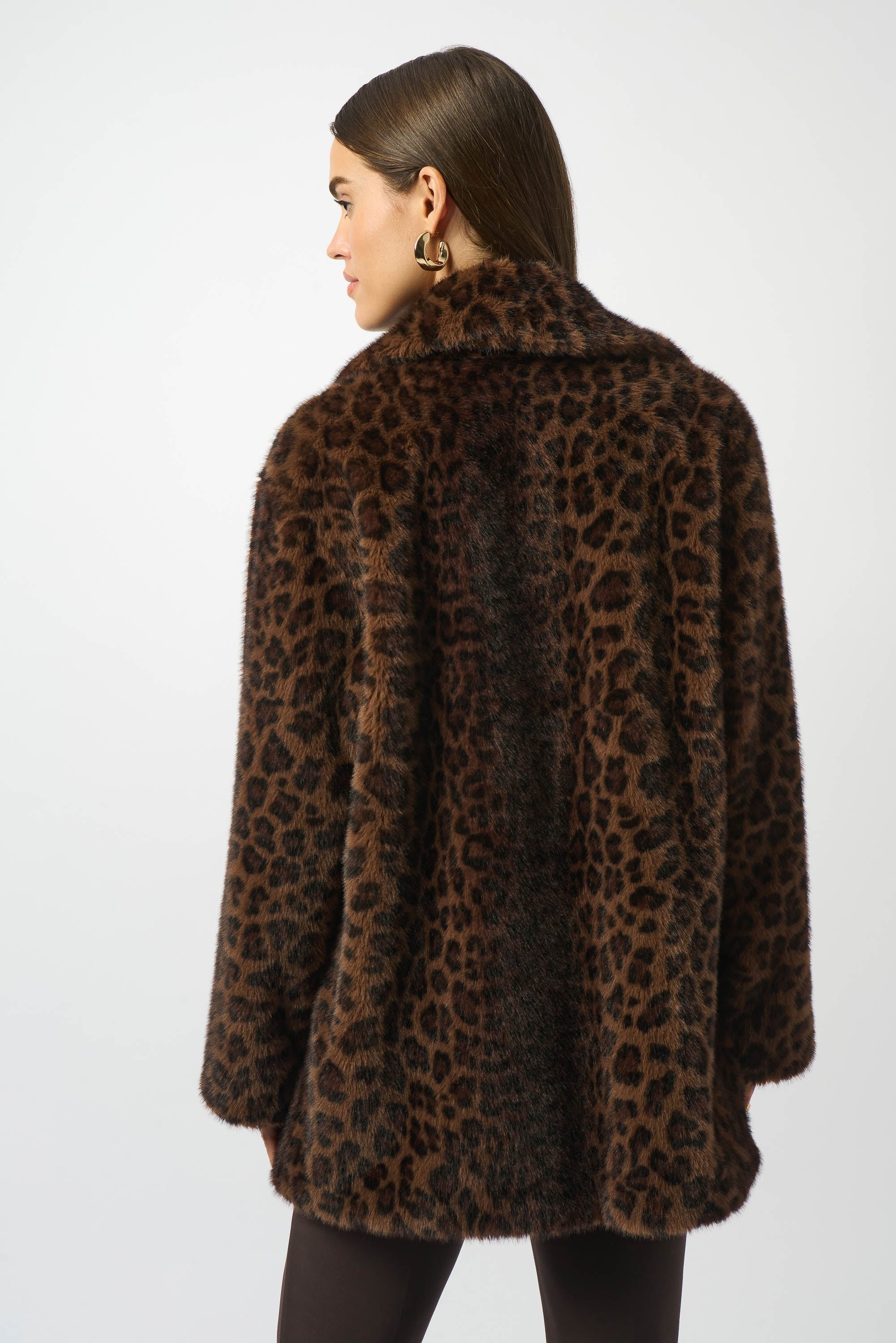 Person wearing a leopard print coat on a white background