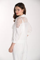 Model wearing a white jacket featuring a lace yoke with sequin embellishments, a relaxed fit, and rolled three-quarter sleeves, shown from the back and side.