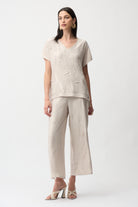 Pleated Satin V-Neck Top styled with wide-leg pants, showcasing elegant pleated fabric and a flattering V-neckline.