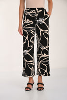 Close-up view of the Avenue Wide-Leg Pant featuring an abstract print, wide-leg silhouette, and relaxed drape with front pockets.
