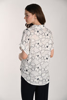 Back view of the Wildflower Stitch Shirt showing the relaxed silhouette, floral embroidered pattern, and airy rayon-linen fabric drape.