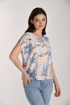 Women's floral print blouse with a relaxed fit, round neckline, and short split sleeves. Styled with light wash jeans, the lightweight woven fabric offers a soft drape and effortless everyday appeal.