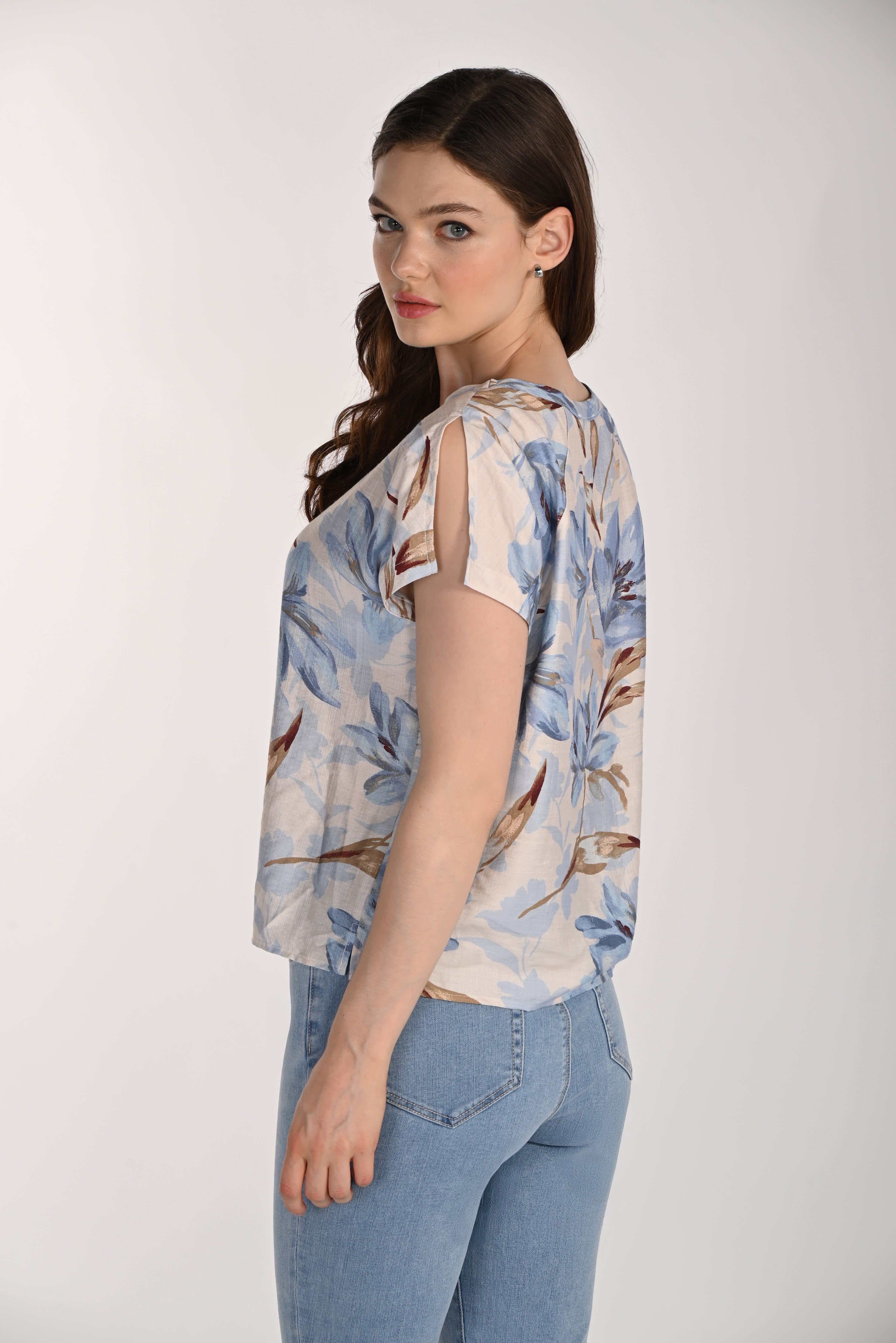 Women's floral print blouse featuring a relaxed silhouette, round neckline, and split sleeve detail. Shown from the back and side to highlight the easy fit, fluid drape, and lightweight woven fabric, paired with light wash jeans.