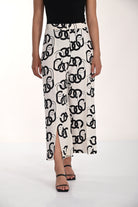 Model wearing a sleeveless fitted top paired with wide-leg chain print pants featuring a relaxed drape, front slit hem detail, and a flowing rayon-linen blend silhouette.