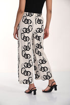 Back view of wide-leg chain print pants with an elasticized waistband and fluid full-length silhouette in a lightweight rayon-linen fabric blend.