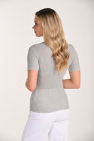 Back view of a women’s silver ribbed shimmer knit top with short sleeves and a streamlined fitted silhouette.