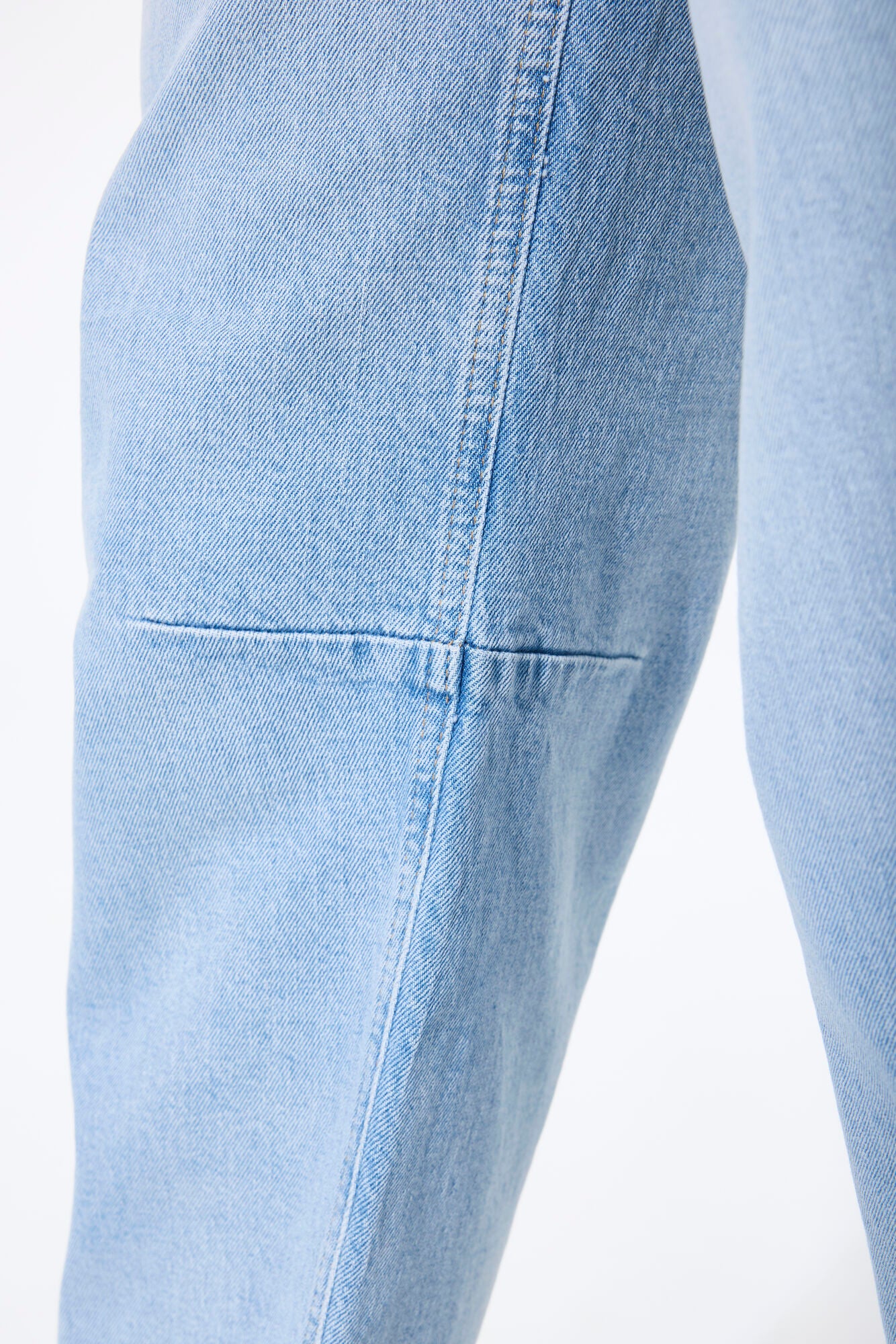 Women’s barrel-leg denim jeans with a relaxed fit, mid-to-high rise waist, and ankle-length cut shown zoomed in. 