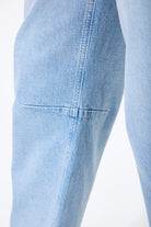 Women’s barrel-leg denim jeans with a relaxed fit, mid-to-high rise waist, and ankle-length cut shown zoomed in. 