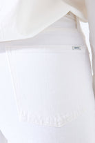 Women's white barrel-leg denim jeans. Zoomed into the pocket detail. 