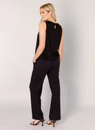 Women's black sleeveless top and straight-leg trousers co-ord set, shown from the back with a keyhole button detail and side pockets.