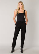 Model wearing women's tapered ankle pants with side pockets and cuffed hems, front view