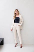 Model wearing women's tapered ankle pants with side pockets and cuffed hems, front view
