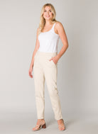 Model wearing women's tapered ankle pants with side pockets and cuffed hems, front view