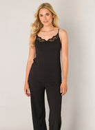 Front view of a lace trim cami with a flattering V-neckline, adjustable spaghetti straps, and a soft, draped silhouette.