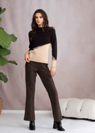 Woman wearing a black and beige sweater