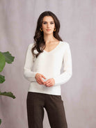 Woman wearing off-white top and brown pants