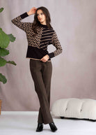 Woman wearing a black and beige patterned sweater