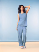 Women’s sleeveless tank top with a relaxed silhouette and soft drape, paired with wide-leg woven pants to show versatility for casual or polished styling.