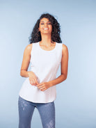 Women’s sleeveless tank top with a relaxed fit, scoop neckline, and smooth knit fabric, styled with slim-fit jeans for an easy everyday look.