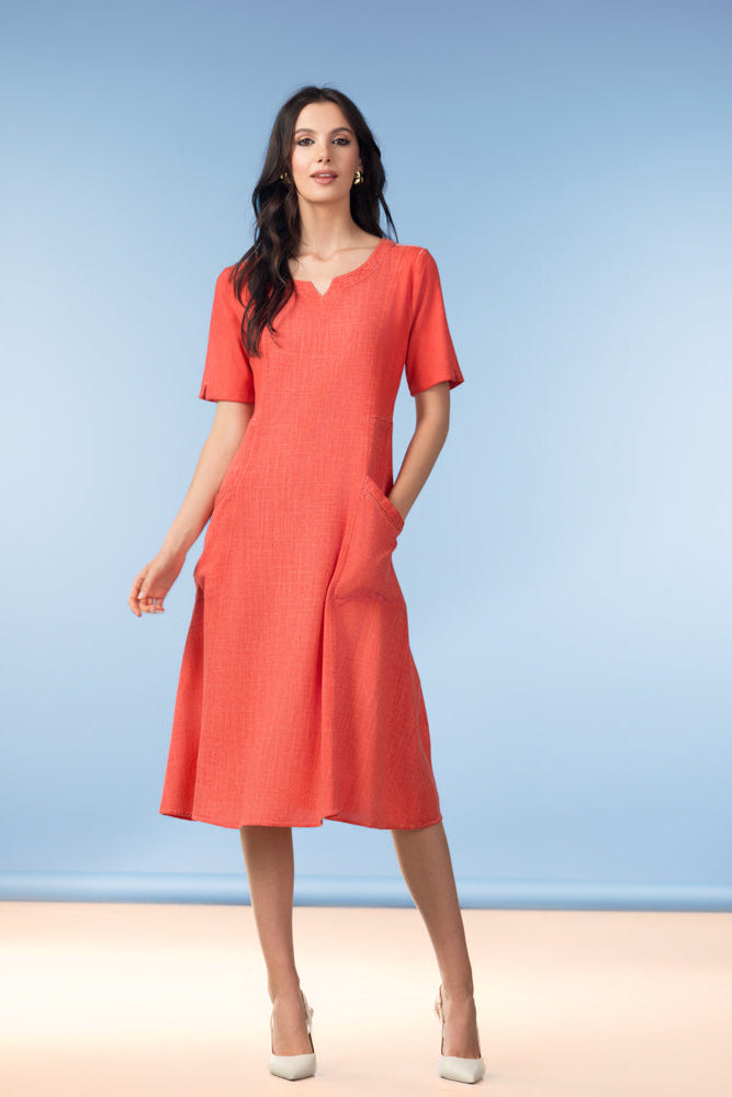 Woman wearing a red dress against a blue background