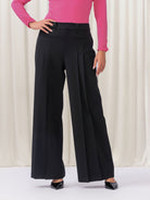 Woman wearing black pants and pink top