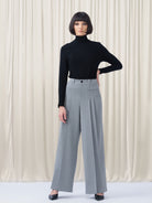 Woman wearing grey pants and black top