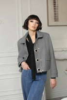 Woman standing in grey jacket