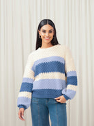 Woman wearing cream and blue sweater