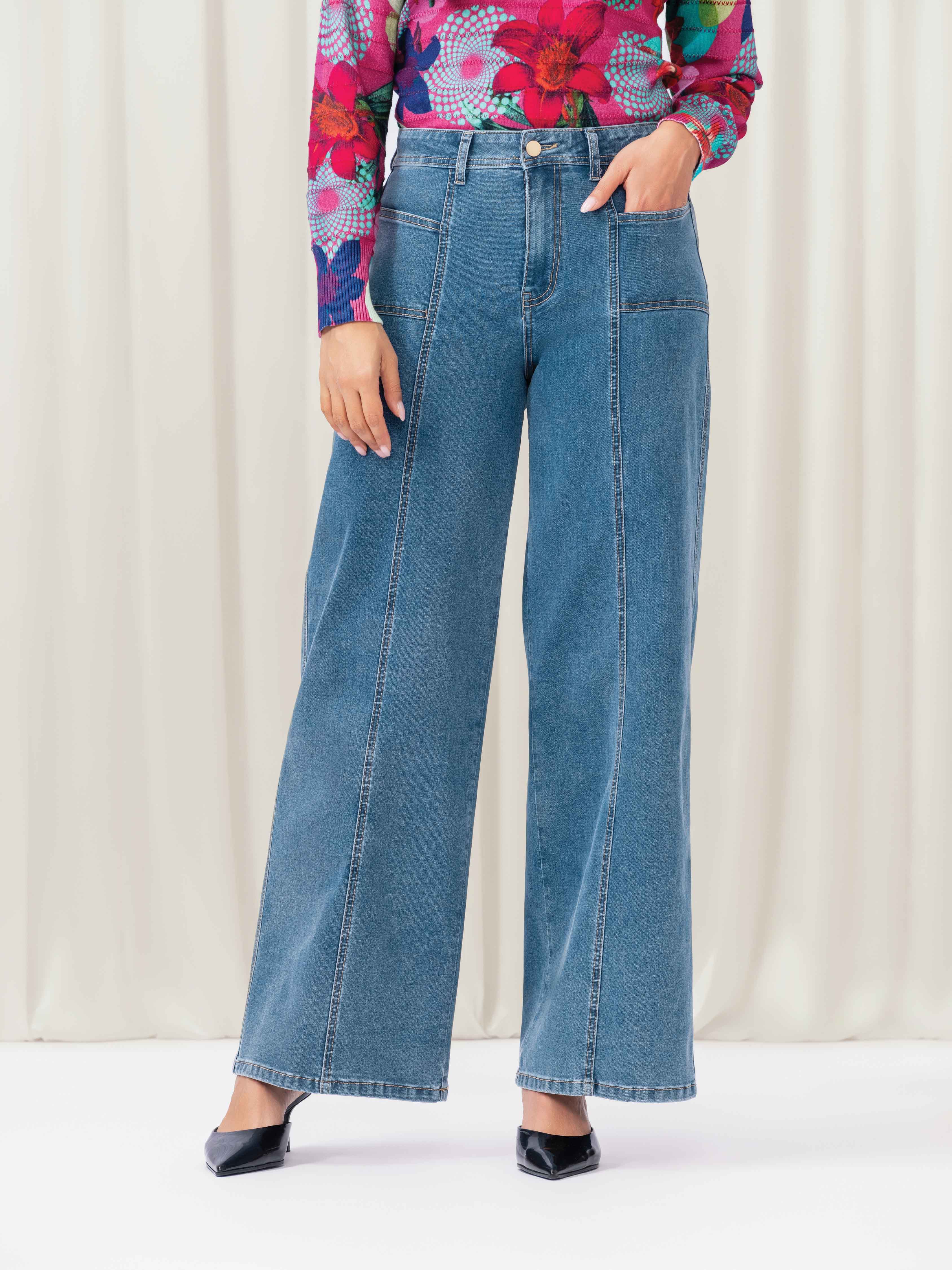 Woman wearing blue jeans and floral top