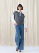 Woman wearing blue jeans and grey top