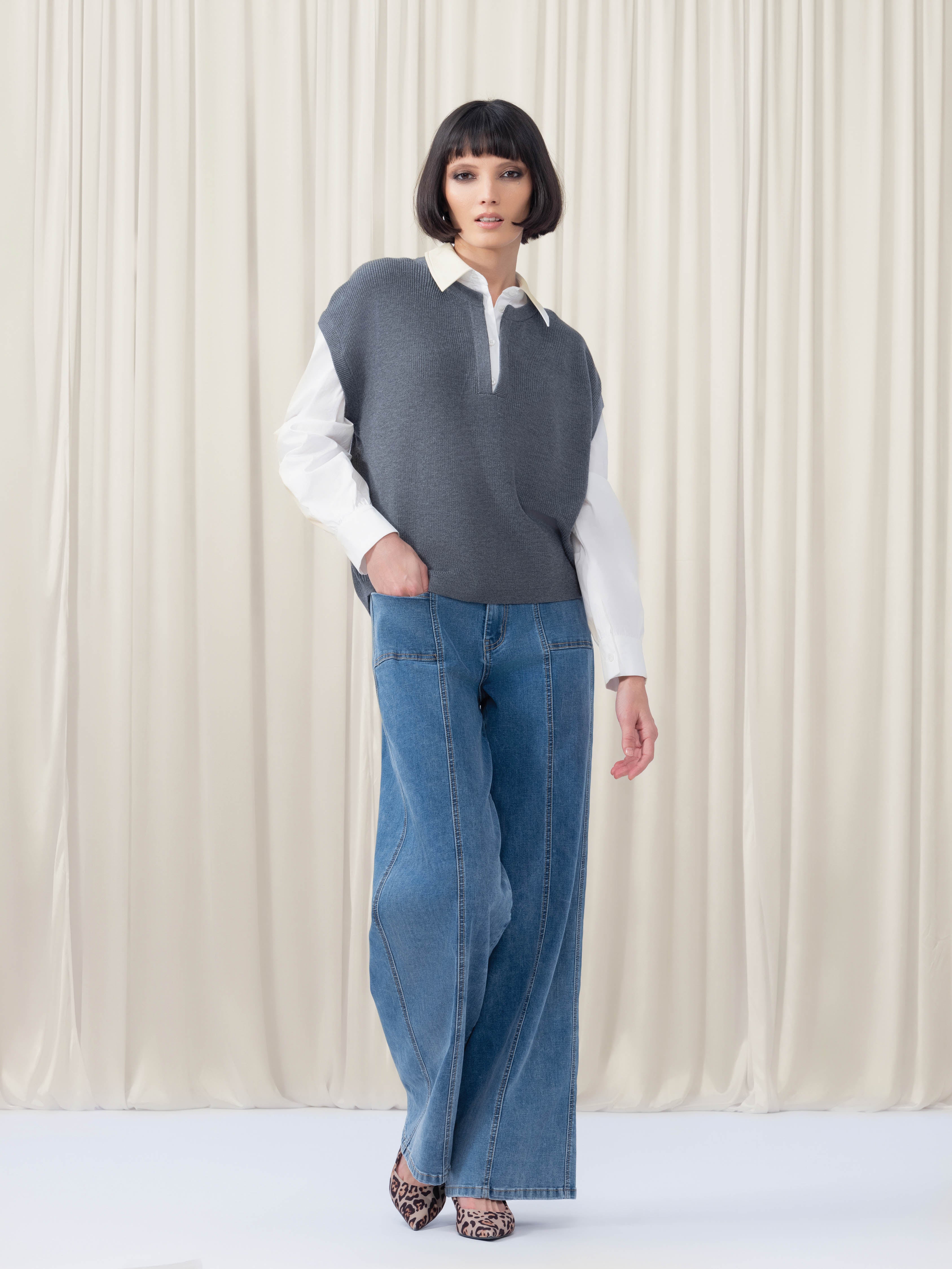 Woman wearing blue jeans and grey top