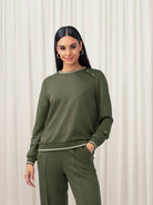 Woman wearing a green outfit against a white background