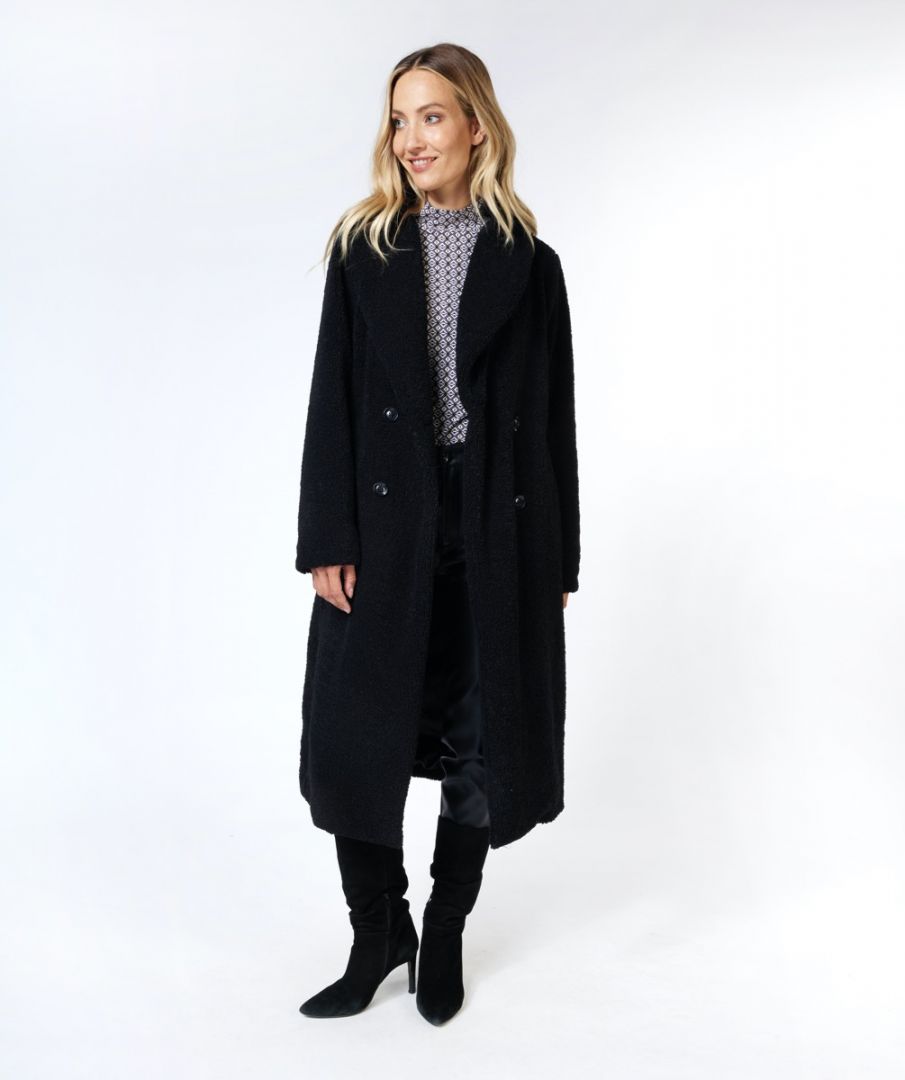 Woman wearing a black coat on a white background