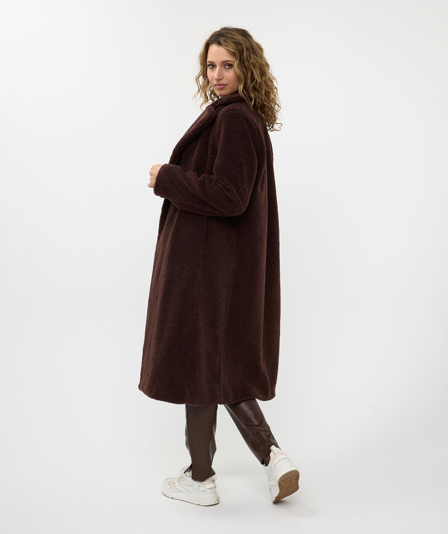 Woman wearing a brown coat on a white background