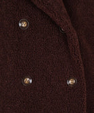 Close-up of a brown textured fabric with buttons