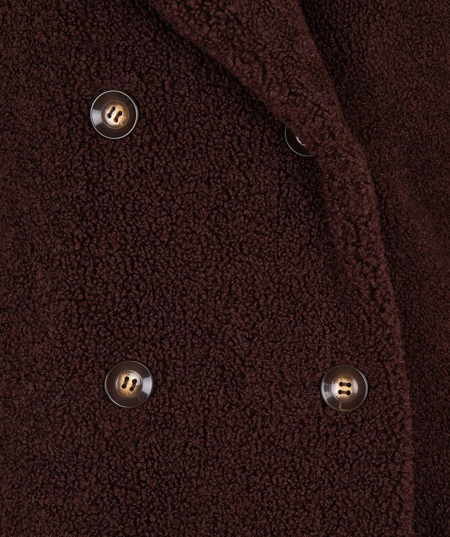 Close-up of a brown textured fabric with buttons