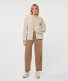 Woman wearing the Haven Textured Knit Cardigan with a crew-neck top, straight-leg trousers, and casual sneakers.