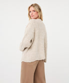 Back view of a woman wearing the Haven Textured Knit Cardigan, showcasing its relaxed fit and textured knit finish.