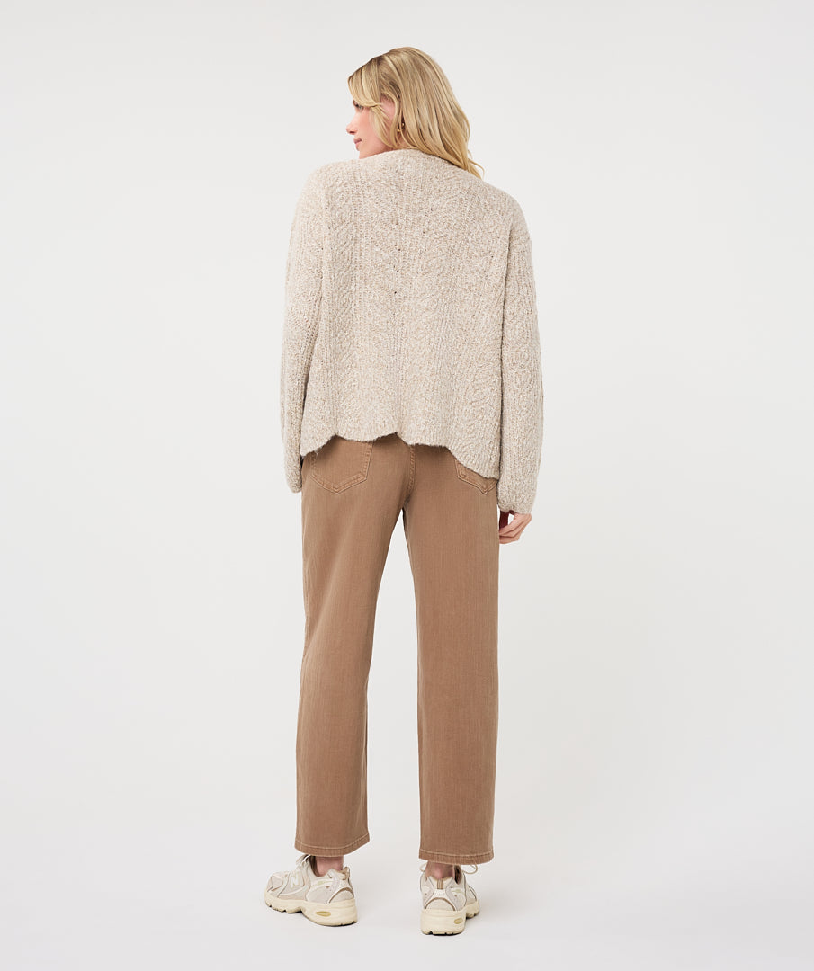 Back view of a woman wearing the Haven Textured Knit Cardigan, showcasing its relaxed fit and textured knit finish.