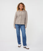 Model wearing the Aspen Button Cardigan with a collared neckline, decorative button closure, long sleeves, and jeans.