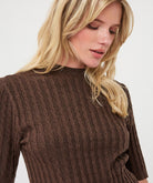 Woman modelling a brown ribbed knit short-sleeve top with a high neckline and fitted silhouette