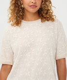 Woman wearing the cream Rosalie Lace Top