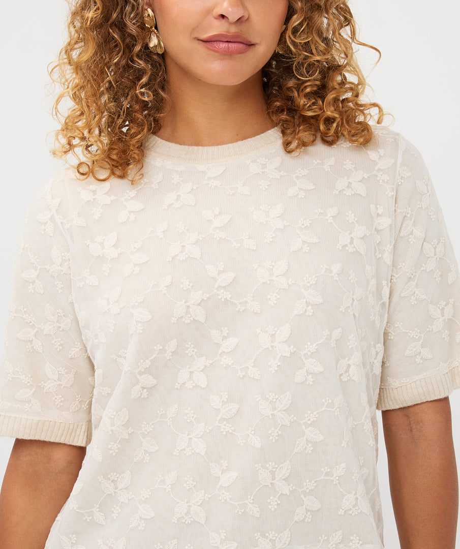 Woman wearing the cream Rosalie Lace Top